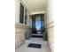 Inviting entryway featuring a stylish black door with glass panels and decorative potted plants at 4545 Oxbow Dr, Brighton, CO 80601