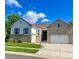 Charming two-story home with a well-manicured lawn, brick accents, and attached two car garage at 4545 Oxbow Dr, Brighton, CO 80601