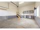 Well-lit two-car garage with storage cabinets and staircase at 4545 Oxbow Dr, Brighton, CO 80601