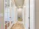 Bright hallway featuring neutral walls, tile flooring and decorative glass panel french doors at 4545 Oxbow Dr, Brighton, CO 80601