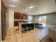 Bright, open kitchen featuring a large island with bar seating and stainless steel appliances at 4545 Oxbow Dr, Brighton, CO 80601