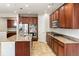 Modern kitchen with granite countertops, stainless steel appliances, and dark wood cabinets at 4545 Oxbow Dr, Brighton, CO 80601