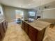 Stylish kitchen island with granite countertops, dark cabinets, and views of the living room at 4545 Oxbow Dr, Brighton, CO 80601