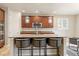 Kitchen island featuring pendant lighting, granite countertops, seating, and stainless steel appliances at 4545 Oxbow Dr, Brighton, CO 80601