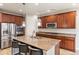 Well-appointed kitchen featuring a large island with seating, stainless steel appliances, and ample cabinet space at 4545 Oxbow Dr, Brighton, CO 80601