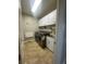 Well-lit laundry room featuring modern appliances and plenty of cabinet storage at 4545 Oxbow Dr, Brighton, CO 80601