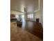 Open concept living room with hardwood floors, fireplace, ceiling fan, and ample natural light at 4545 Oxbow Dr, Brighton, CO 80601