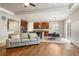 Open-concept living area showcasing hardwood floors, modern furnishings, and seamlessly flowing into the kitchen at 4545 Oxbow Dr, Brighton, CO 80601