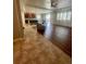 Open-concept living area with hardwood floors, a kitchen island, and a comfortable sofa at 4545 Oxbow Dr, Brighton, CO 80601
