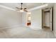Spacious bedroom with neutral walls, plush carpet, ceiling fan, and adjoining bathroom at 4545 Oxbow Dr, Brighton, CO 80601