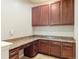 Dedicated home office space featuring built-in cabinets, granite countertops, and ample storage at 4545 Oxbow Dr, Brighton, CO 80601