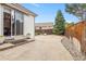 Stamped concrete patio with sliding door and fenced backyard at 4545 Oxbow Dr, Brighton, CO 80601