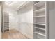 Spacious walk-in closet with built-in shelving and carpeted floor at 4545 Oxbow Dr, Brighton, CO 80601