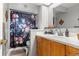 Full bathroom with tile floors, wood cabinets, and a shower with a floral curtain at 12603 E Ohio Ave, Aurora, CO 80012
