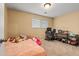 Bedroom features neutral walls, carpet, and a window providing natural light at 12603 E Ohio Ave, Aurora, CO 80012
