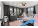 Bedroom with dark accents, wood floor, ceiling fan and lots of natural light at 12603 E Ohio Ave, Aurora, CO 80012