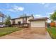 Charming home with a two-car garage, brick accents, and a well-maintained front yard at 12603 E Ohio Ave, Aurora, CO 80012