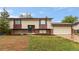 Charming two-story home with a brick facade, attached garage, and front yard with lawn at 12603 E Ohio Ave, Aurora, CO 80012