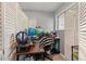 This home office is next to a window with natural lighting and folding privacy screens at 12603 E Ohio Ave, Aurora, CO 80012