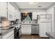 Bright kitchen with white cabinets, granite countertops, and stainless steel appliances at 12603 E Ohio Ave, Aurora, CO 80012