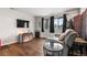 Comfortable living space features wood floors, natural light and a gray sofa at 12603 E Ohio Ave, Aurora, CO 80012