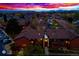 Aerial view of a well-maintained neighborhood at sunset, showcasing stunning mountain views in the distance at 7080 W 20Th Ave # 202, Lakewood, CO 80214