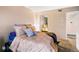 Relaxing bedroom with a large bed, a mirror closet, and neutral decor at 7080 W 20Th Ave # 202, Lakewood, CO 80214