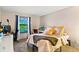 Bright bedroom with a window, plush bed, and designated workspace at 7080 W 20Th Ave # 202, Lakewood, CO 80214