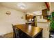 Dining room with wooden table, dark cabinets, and modern fixtures at 7080 W 20Th Ave # 202, Lakewood, CO 80214