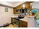 A close-up view of the kitchen's stainless steel appliances and custom wood cabinets at 7080 W 20Th Ave # 202, Lakewood, CO 80214
