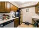 A kitchen view showcases stainless steel appliances, wooden cabinets, and a wine rack at 7080 W 20Th Ave # 202, Lakewood, CO 80214