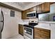 This kitchen features stainless steel appliances, stylish cabinets, and easy access to the living space at 7080 W 20Th Ave # 202, Lakewood, CO 80214
