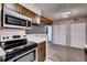 Contemporary kitchen with stainless steel appliances, a breakfast bar, and modern lighting fixtures at 7080 W 20Th Ave # 202, Lakewood, CO 80214
