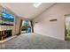 Living room with stone fireplace, vaulted ceiling, and balcony access at 7080 W 20Th Ave # 202, Lakewood, CO 80214