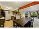 Open floor plan featuring kitchen with wood cabinets and a stone fireplace near a sliding glass door to a deck at 7080 W 20Th Ave # 202, Lakewood, CO 80214