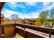 Balcony view of the community, featuring lush trees and a parking area at 7080 W 20Th Ave # 202, Lakewood, CO 80214