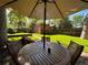 Relaxing patio area with a table and chairs, under an umbrella at 536 S High St, Denver, CO 80209