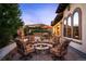 Outdoor entertaining space with dining table, outdoor fireplace, and fire pit at 2117 S Juniper St, Lakewood, CO 80228