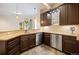 Basement bar with granite countertops, stainless steel appliances, and dark wood cabinets at 2117 S Juniper St, Lakewood, CO 80228