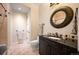 Bathroom with a granite counter, a decorative mirror, and a tiled shower at 2117 S Juniper St, Lakewood, CO 80228