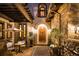 Charming courtyard entrance with stone accents, mature landscaping, and outdoor seating area at 2117 S Juniper St, Lakewood, CO 80228