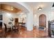 Formal dining room featuring hardwood floors, elegant lighting, and an arched entryway at 2117 S Juniper St, Lakewood, CO 80228