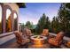 Inviting outdoor fire pit area with comfortable seating, stone wall, and elegant landscaping at 2117 S Juniper St, Lakewood, CO 80228