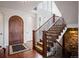 Grand foyer with hardwood floors, wrought iron staircase, and elegant front door creating a welcoming entrance at 2117 S Juniper St, Lakewood, CO 80228