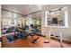Home gym with mirrored wall, exercise equipment, pull-up station, and natural light at 2117 S Juniper St, Lakewood, CO 80228