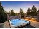 Backyard hot tub with scenic views and privacy landscaping at 2117 S Juniper St, Lakewood, CO 80228