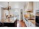 Well-lit kitchen with custom cabinets, island, and stainless steel appliances at 2117 S Juniper St, Lakewood, CO 80228