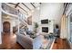 Spacious living room featuring a fireplace, high ceilings, and staircase at 2117 S Juniper St, Lakewood, CO 80228