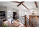 Bright living room with exposed beams, hardwood floors, and a decorative wrought iron staircase at 2117 S Juniper St, Lakewood, CO 80228