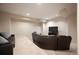 Cozy living room with plush carpet, leather sofas, and a modern TV at 2117 S Juniper St, Lakewood, CO 80228